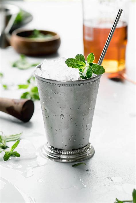 The mint julep - Apr 9, 2023 · Instructions. Place the mint leaves in the bottom of a glass and top with simple syrup or sugar. Using a muddler, crush the leaves until they begin to break down. Add the bourbon to the glass and stir. Fill the glass with ice and top with the seltzer water. Garnish with mint and serve immediately. 